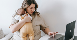 Blog banner featuring working woman holding baby